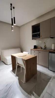 a room with a table and a kitchen with a bed at Dimora Cozy Retreat in Chania Old Town in Chania Town