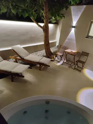 a room with a tree and chairs and a tub at Dimora Cozy Retreat in Chania Old Town in Chania Town