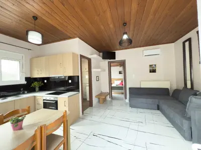 a kitchen and living room with a couch and a table at Suites Near Elafonisi in Élos