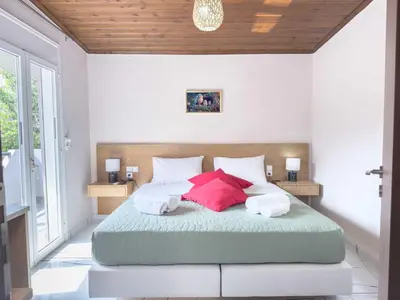 a bedroom with a bed with two pillows on it at Suites Near Elafonisi in Élos
