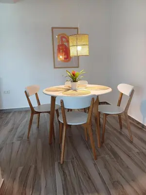 a dining room table and chairs with a table and a lamp at Wave Loft in Chania Town