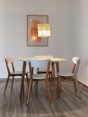 a dining room table and chairs with a lamp at Wave Loft in Chania Town