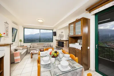 a living room with a table and a couch at Aloni Villa in Káïna