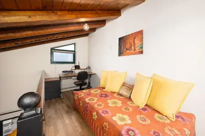 a bedroom with a bed with yellow pillows and a desk at Aloni Villa in Káïna