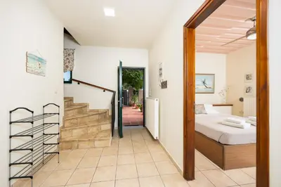 a bedroom with a bed and a staircase leading into a room at Aloni Villa in Káïna