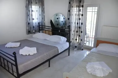 a bedroom with two beds with towels on them at Villa Esperado Gardens Maleme in Maleme