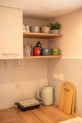 a kitchen shelf with a pot and a blender on it at Anamniseis Giorgio Falasarna in Plátanos