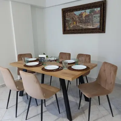 a dining room table with chairs and a picture on the wall at Kornaros House in Chania Town