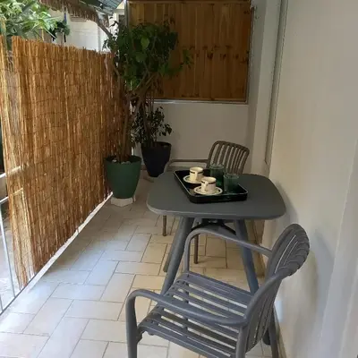 a small table and a chair on a patio at Kornaros House in Chania Town