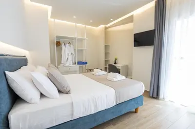 a bedroom with a bed with white sheets and pillows at Chania Moments in Chania Town