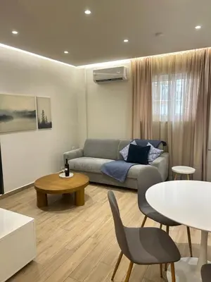 a living room with a couch and a table at Chania Moments in Chania Town