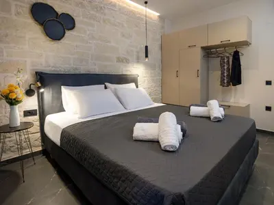 a bedroom with a large bed with two towels at PanStel Twin Villas with private pools and jacuzzi in Ayiá