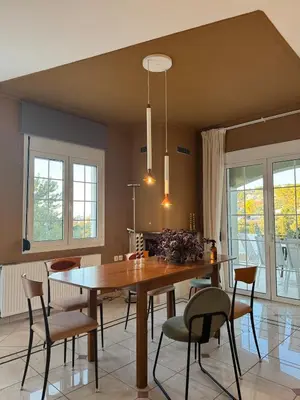 a dining room with a wooden table and chairs at Nature spacious apt, 2km from Chania old town, private parking in Chania Town
