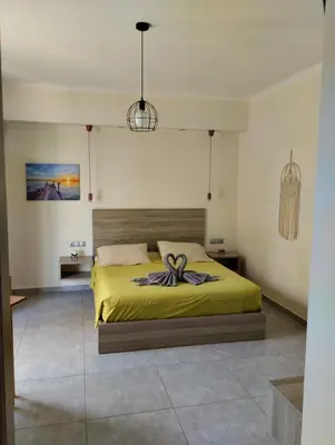 a bedroom with a bed with a bow on it at Callista sea view or garden in Kissamos