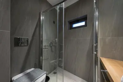 a bathroom with a shower with a glass shower stall at Mirma City apartment2 Old Town in Chania Town