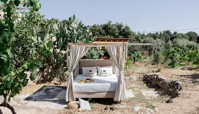 a bed in the middle of a field at Star Sleep Dourakis Winery Chania in Alikampos