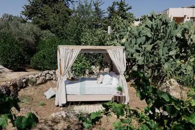 a bed in a gazebo in a garden at Star Sleep Dourakis Winery Chania in Alikampos