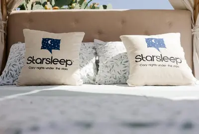 a bed with pillows on top of it at Star Sleep Dourakis Winery Chania in Alikampos