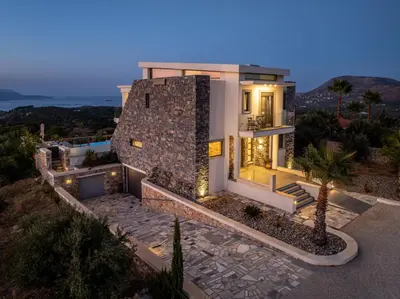 a villa with a view of the ocean at night at Villa Grand Fysaeri in Vamos
