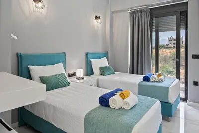 a bedroom with two beds with towels on them at Villa Grand Fysaeri in Vamos