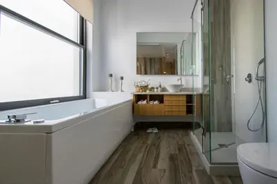 a bathroom with a tub and a sink and a shower at S&K Villas in Kalamaki Chanion