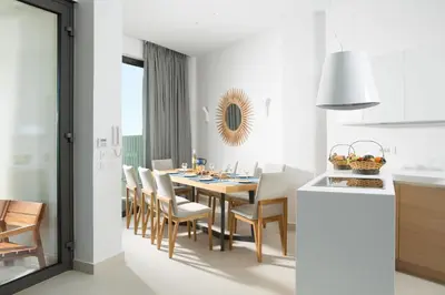 a kitchen and dining room with a table and chairs at S&K Villas in Kalamaki Chanion