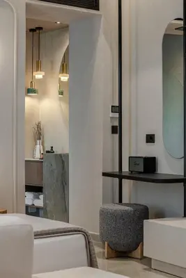 a bedroom with a bed and a stool and mirrors at Amara Luxury Suites With Private Hot Tub in Chania Town