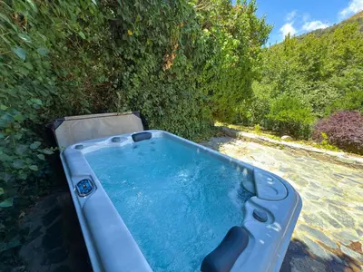 a hot tub in a yard with trees at Elafonisi Manor with Private Pool & Jaccuzi in Perivólia