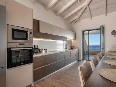 a kitchen with a table with chairs and a dining room at Casa Domenica, 2 bedroom seaside home in Chania Town