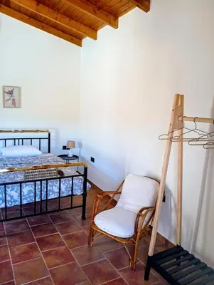 a room with a ladder and a chair and a bed at Wild Tulip Escape in Kolymvari