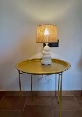 a table with a lamp on top of it at Wild Tulip Escape in Kolymvari