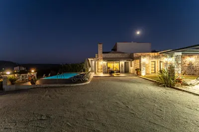 a villa with a swimming pool at night at Villa Resi in Vamos