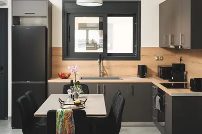a kitchen with a table with chairs and a sink at LUV Group of 4 Villas in Kathiana in Kathiana
