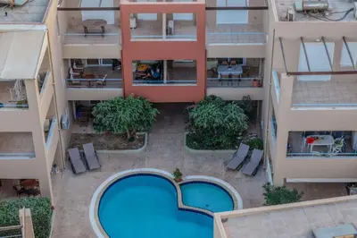 an overhead view of an apartment building with a swimming pool at Helena's Dream Home in Maleme