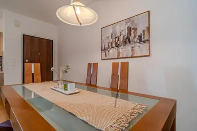 a dining room with a glass table and a picture at Helena's Dream Home in Maleme