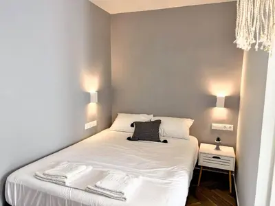 a bedroom with a white bed with two towels on it at Amfitriti 30meter to beach, 6min Old Town, 2BD 4PL in Chania Town