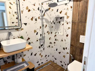 a bathroom with a shower and a sink at Amfitriti 30meter to beach, 6min Old Town, 2BD 4PL in Chania Town