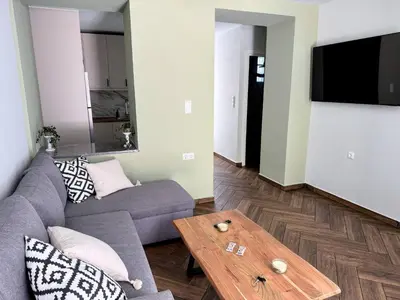 a living room with a couch and a coffee table at Amfitriti 30meter to beach, 6min Old Town, 2BD 4PL in Chania Town