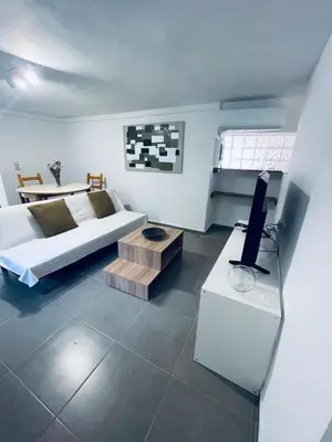 a room with a bed and a table with a tv at Old Cellar House in Moní