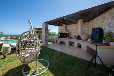 a grill in a yard with a tv on a lawn at Villa Lady Dafni with private heated pool in Maleme