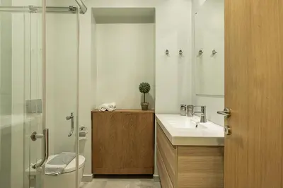 a bathroom with a toilet and a sink and a shower at Myrtia Beach House in Tersanas