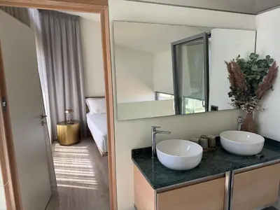a bathroom with two sinks and a mirror at Alky Luxury Villa in Chania Town