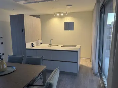 a kitchen with a sink and a table with chairs at Alky Luxury Villa in Chania Town