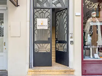a front door of a store with a sign on it at Harbour - Spacious Unique 2-Balcony Apartment in Chania Old Town in Chania Town