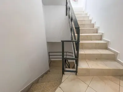 a stairway with a black railing and a set of stairs at Harbour - Spacious Unique 2-Balcony Apartment in Chania Old Town in Chania Town