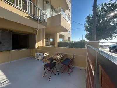 a patio with a table and chairs on a balcony at A&G mare in Chania Town