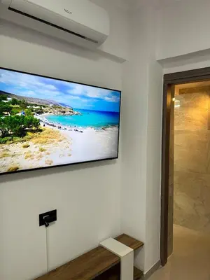 a flat screen tv hanging on a wall at A&G mare in Chania Town