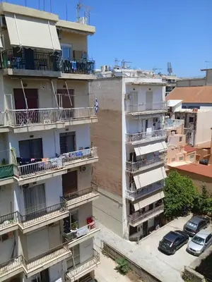 an apartment building with balconies and a parking lot at Marilu apartment in the center of Chania in Chania Town