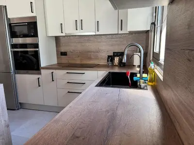 a kitchen with white cabinets and a sink at Matthew's house in Kalamítsion Alexándrou