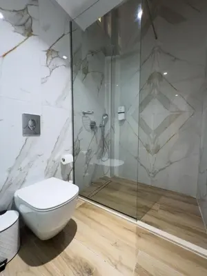 a bathroom with a toilet and a shower at Deluxe Center Suites in Chania Town